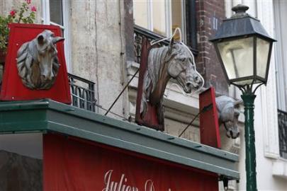 Metal horse heads are seen above a closed horsemeat butcher shop in Paris